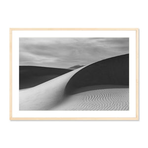 Guadalupe Dunes black and white framed photography print showcasing smooth sand patterns and dramatic shadows under a cloudy sky, perfect for curated wall art or fine art photography collections.