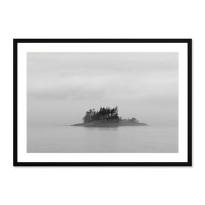 Framed black and white photography print of a misty island with trees surrounded by calm water, titled Inside Passage Island, perfect for moody landscape wall art.